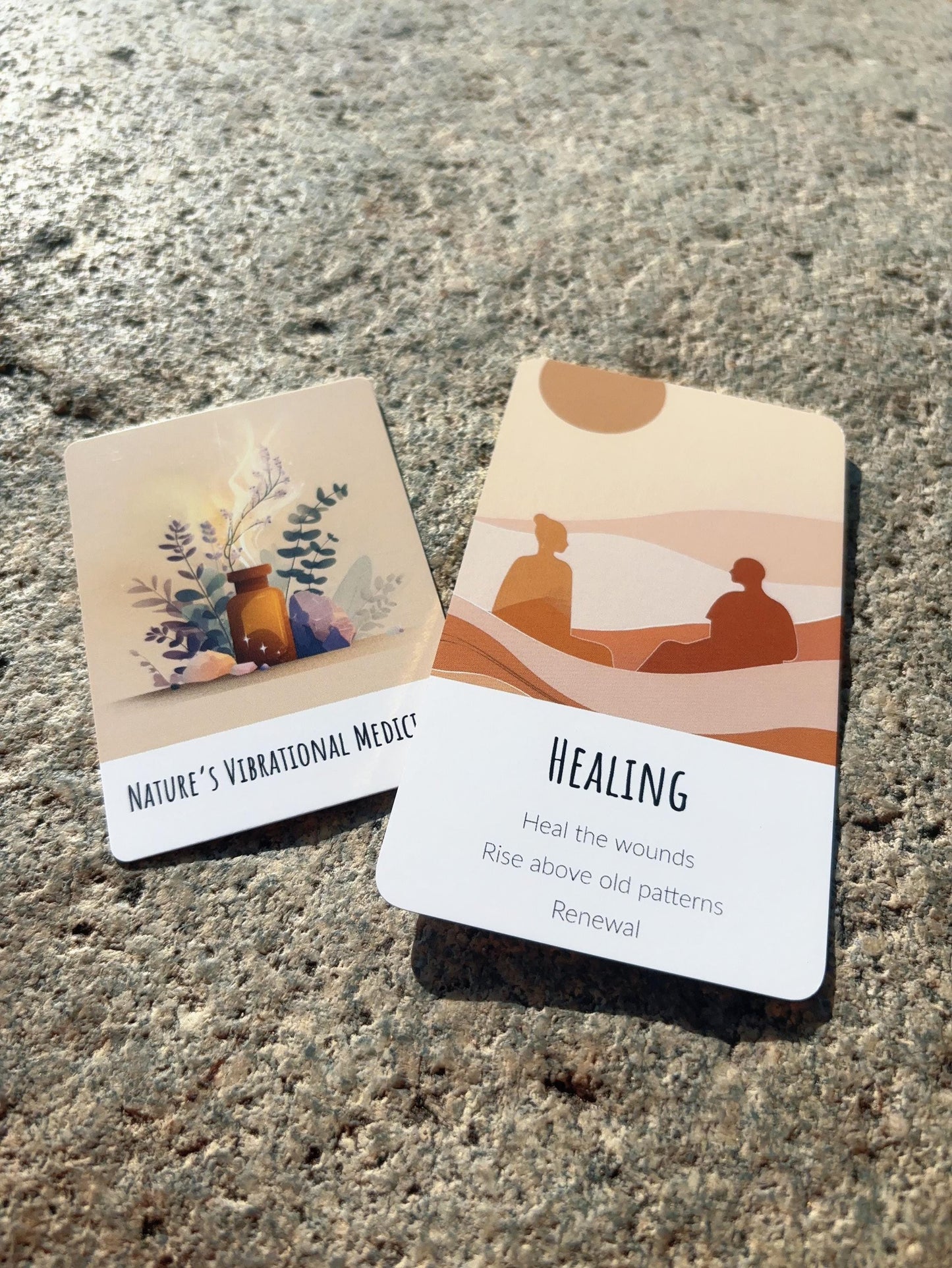 Abundance Oracle Deck for reflection, guidance, and intuitive reading. Two cards on a textured surface with one labeled 'Healing'.