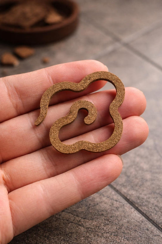 Handheld cloud incense piece made from natural agarwood with carved design