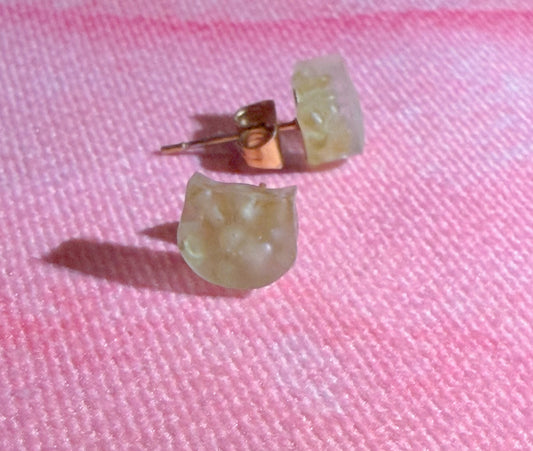 Side view of peridot stud earrings in cat head shape showing thickness and matte texture