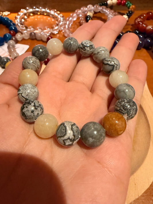 close up of gray patterned jasper beads with yellow aventurine bracelet