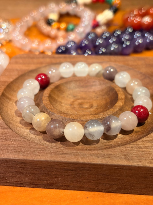 close up of lavender jade beads with red cinnabar accents crystal bracelet