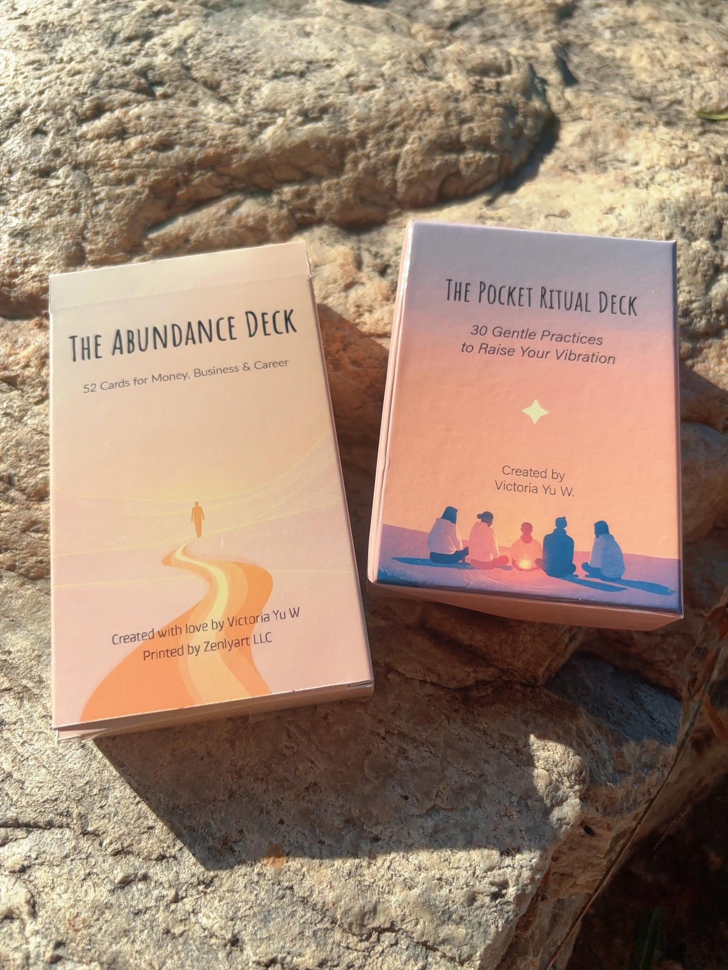 Abundance Oracle Deck and companion decks displayed together on stone, nalmely 'The Abundance Deck' and 'The Pocket Ritual Deck'