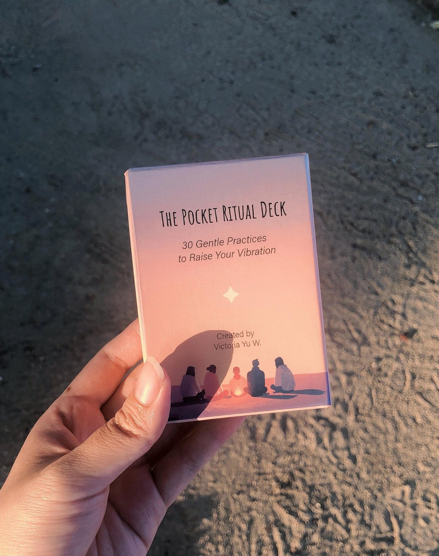 Hand holding 'The Pocket Ritual Deck' Magnetic Gift Box against a textured surface