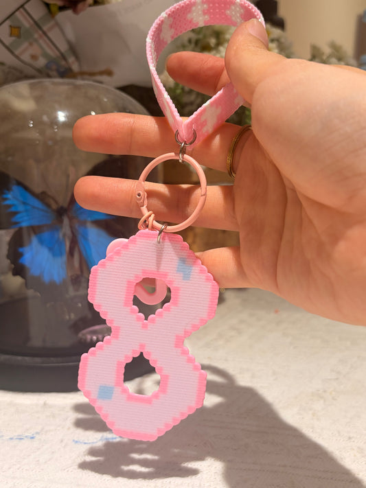 Handmade pink pixel art keychain held in hand, created by Zenlyart Studio as a custom keepsake gift.