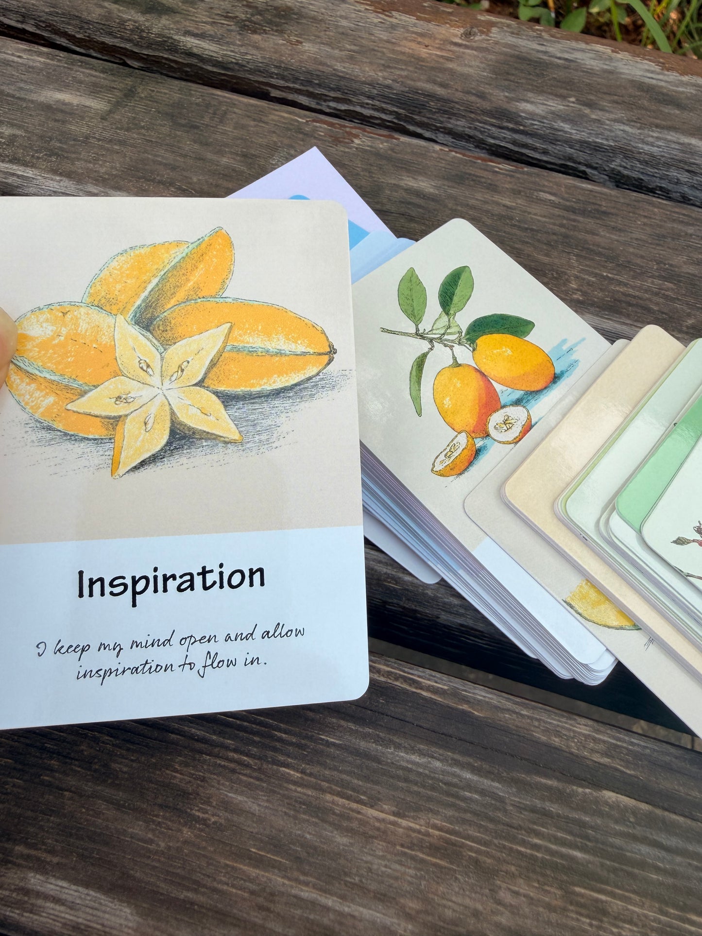 Inspiration card from The Fruit Deck displayed with seasonal fruit illustrations and guidance message.