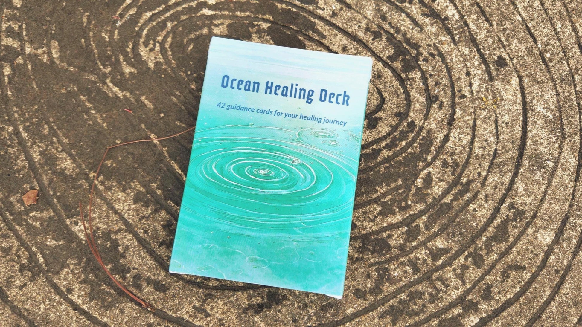 Ocean Healing Oracle Deck box placed on textured wood surface