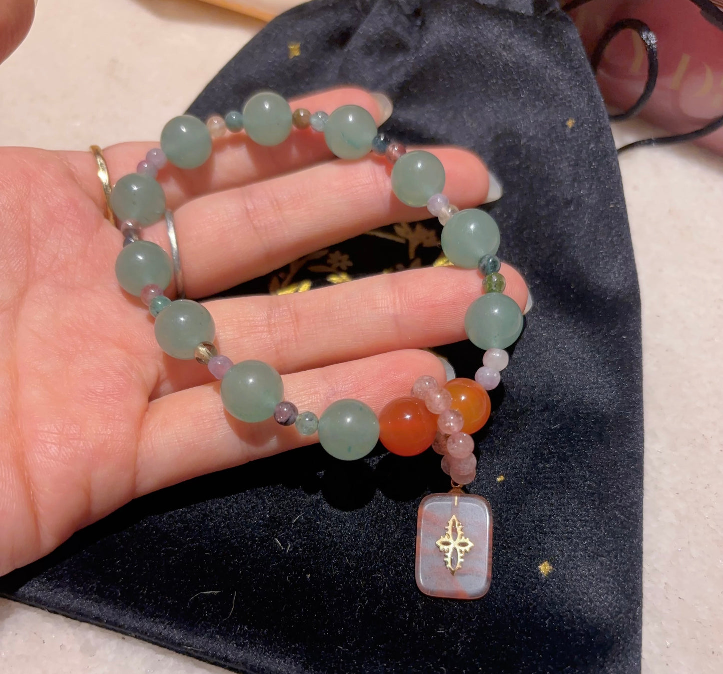 Personalized Oracle Inspired gemstone bracelet show on hand, custom designed around a customer’s intention and oracle card.
