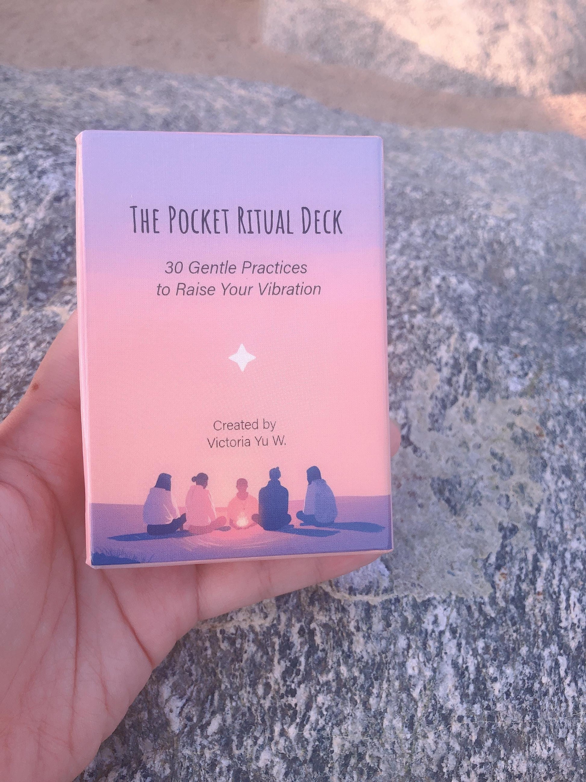 Pocket Ritual Oracle Deck box held in hand outdoors in natural light