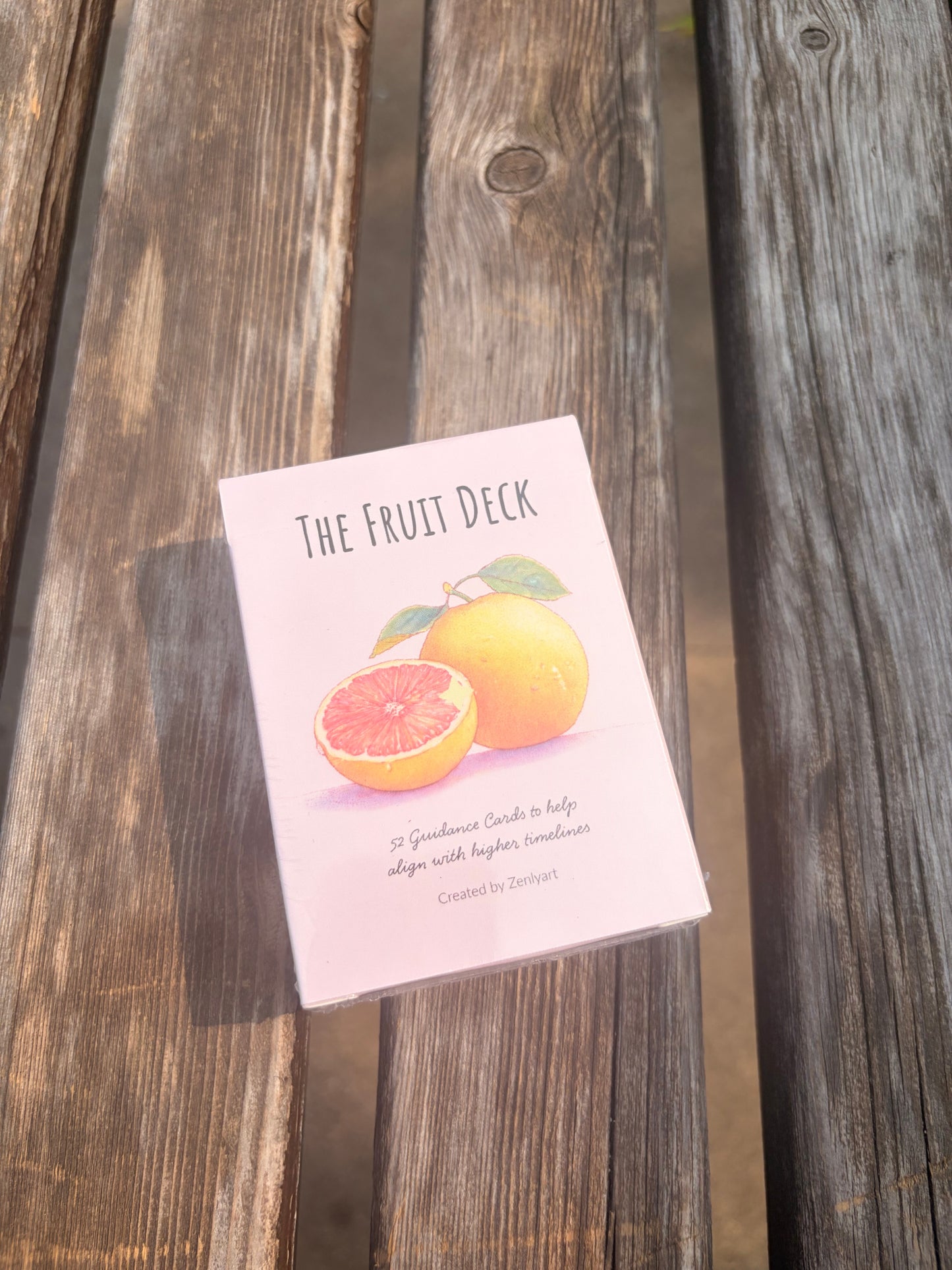 The Fruit Deck oracle card box featuring watercolor citrus artwork and seasonal guidance theme.
