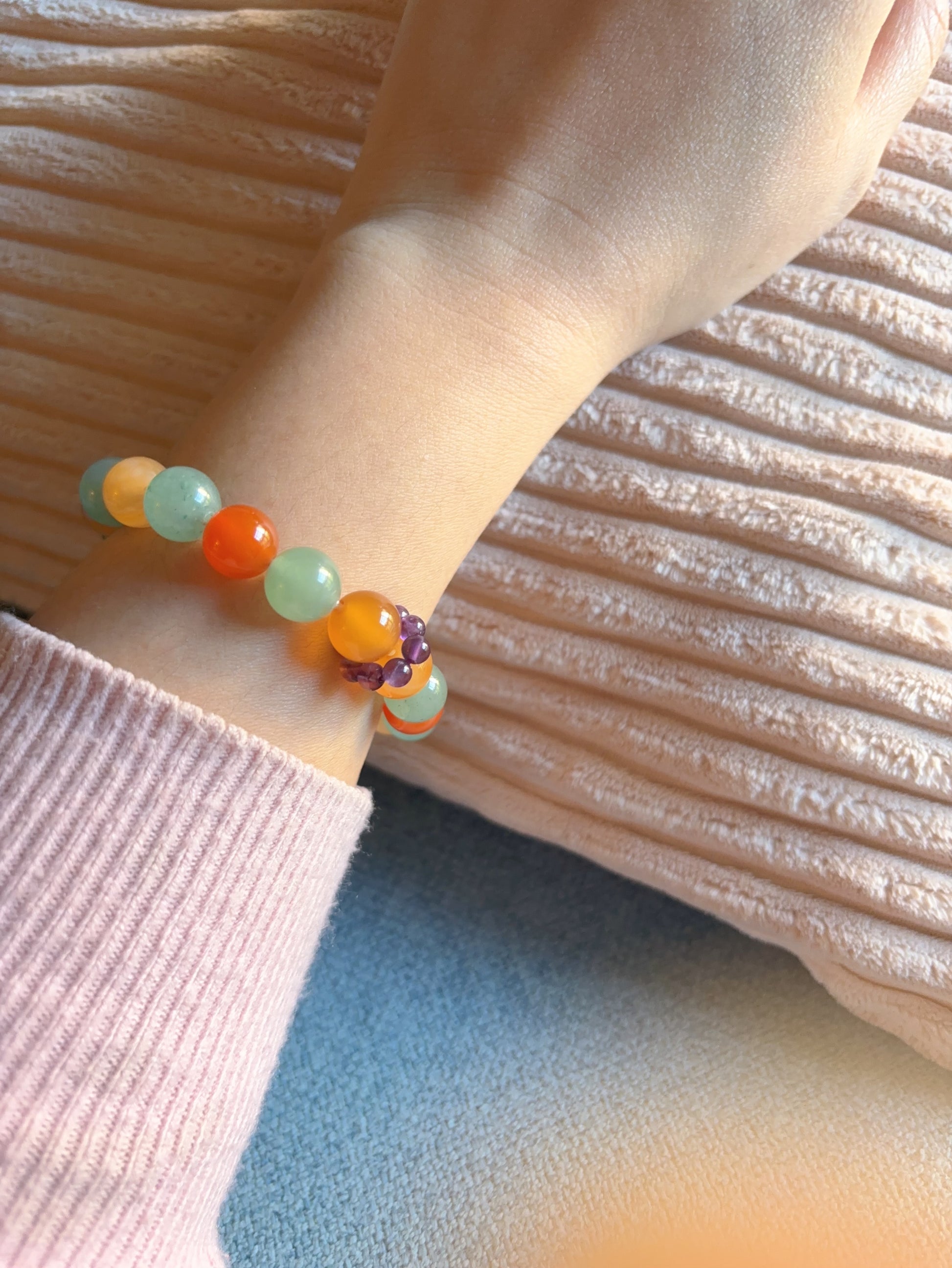 green aventurine and red agate bracelet worn on wrist soft color crystal bracelet lifestyle