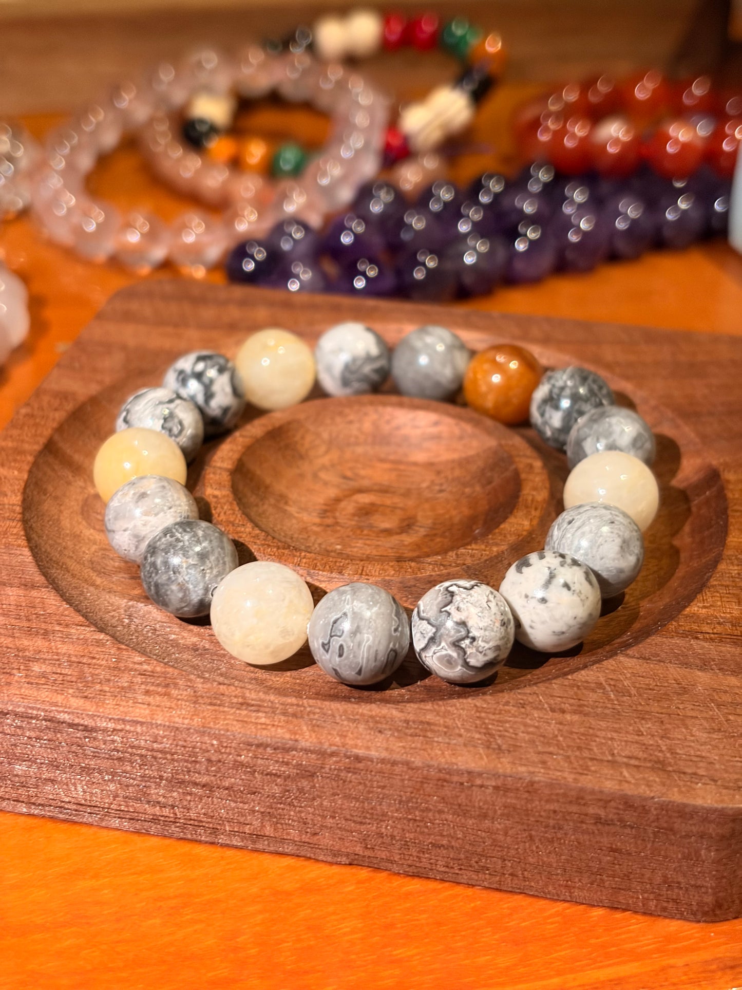 picture jasper and yellow aventurine bracelet on wooden tray earthy tones