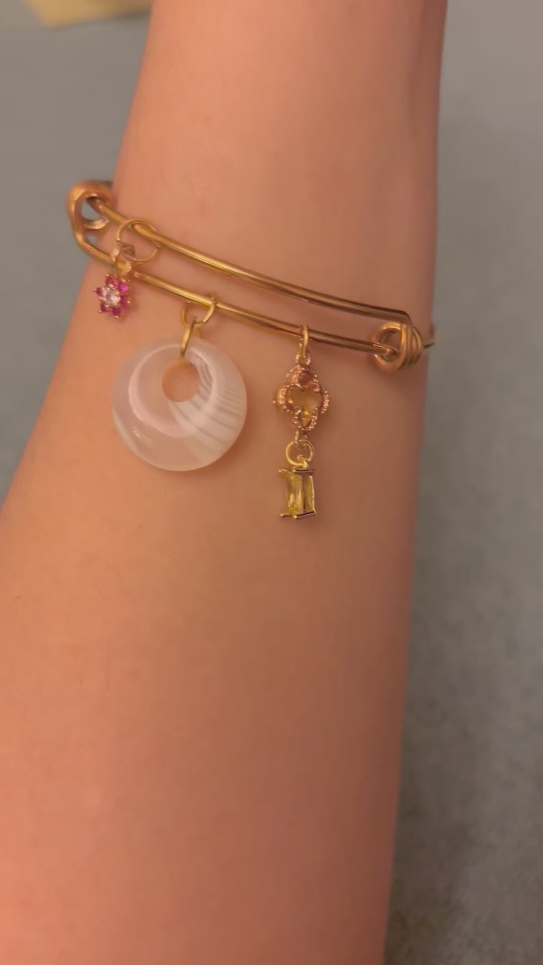 opalite charm bangle bracelet worn on wrist showcasing the styling
