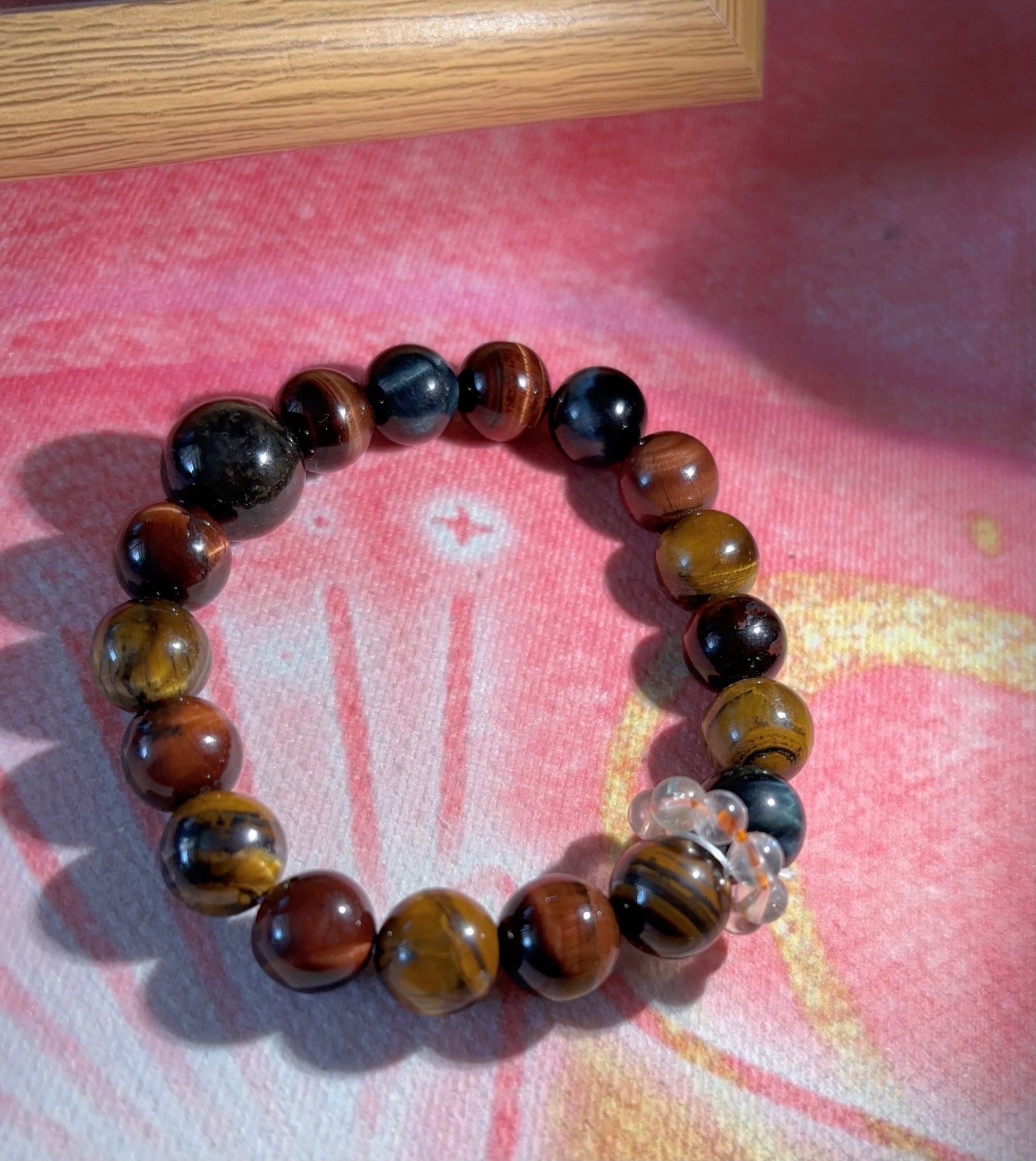 tiger eye bracelet on pink background warm toned crystal bracelet protection and confidence jewelry