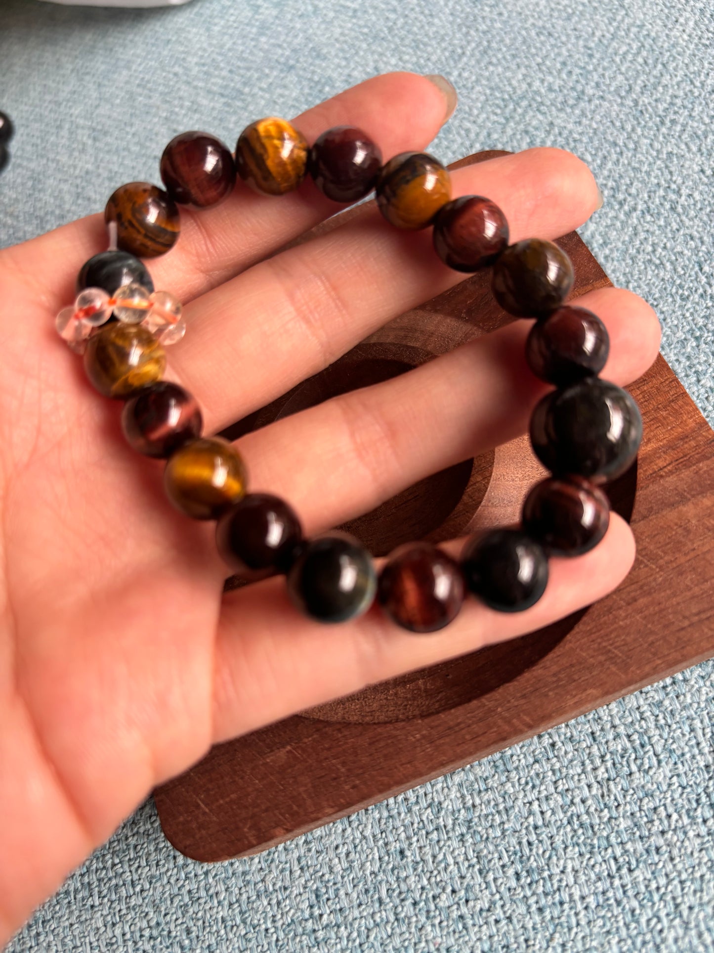 tri color tiger eye bracelet in hand with jade beads and citrine accent natural crystal jewelry